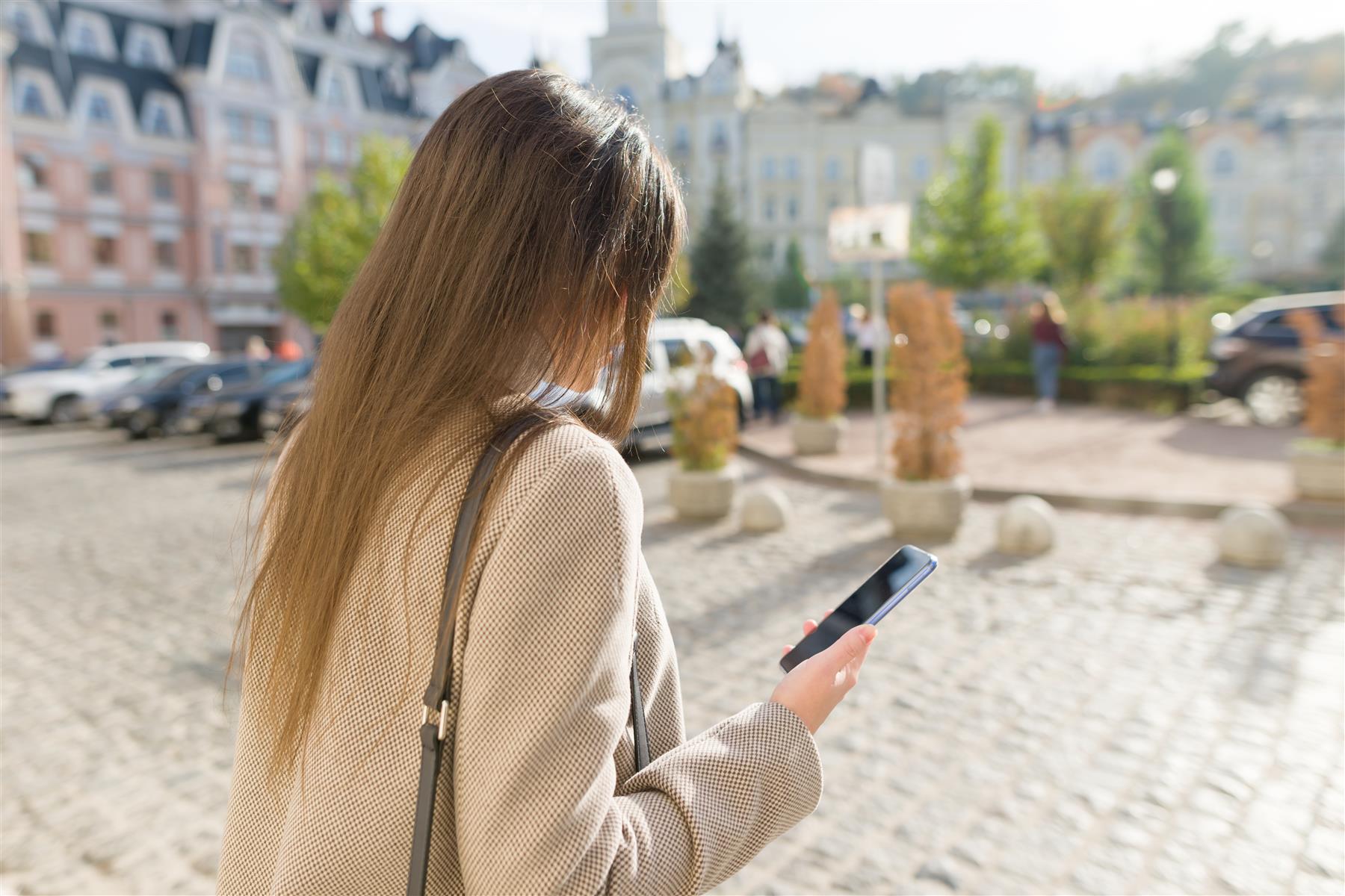 Traveler using a smartphone in a European city square